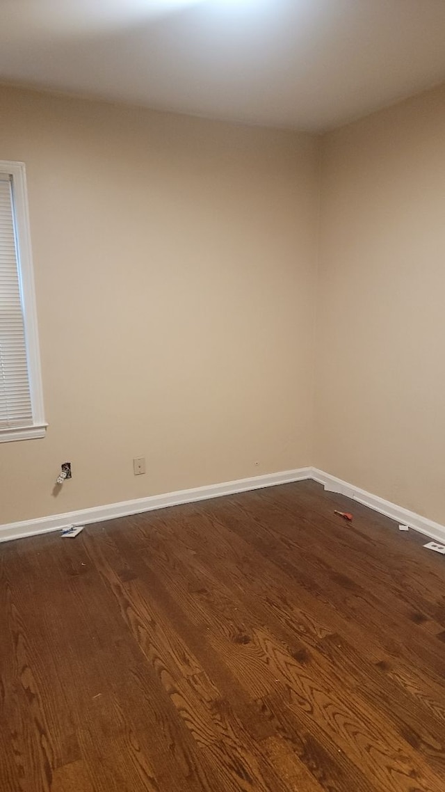 empty room featuring dark wood-type flooring