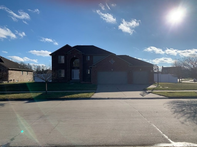 view of front of property featuring a garage and a front lawn