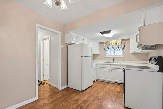 kitchen with light hardwood / wood-style floors, sink, white appliances, and white cabinets