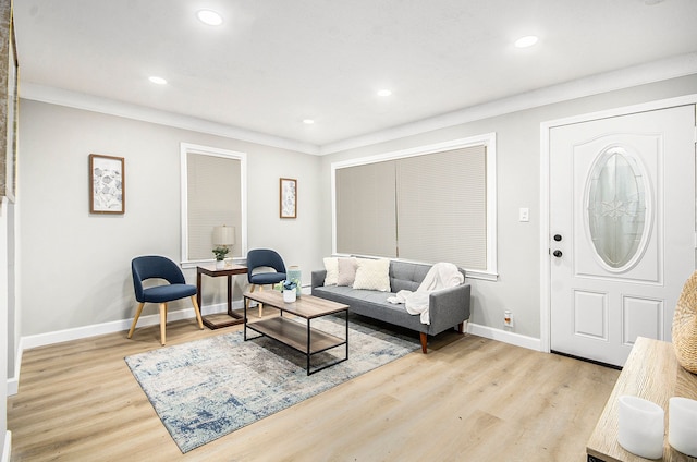 living room featuring light hardwood / wood-style flooring and crown molding