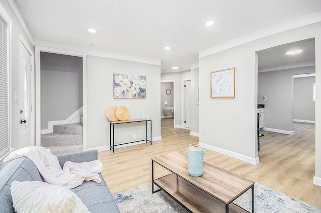 living room featuring light hardwood / wood-style flooring and ornamental molding