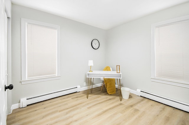 office area featuring a baseboard radiator and light hardwood / wood-style flooring