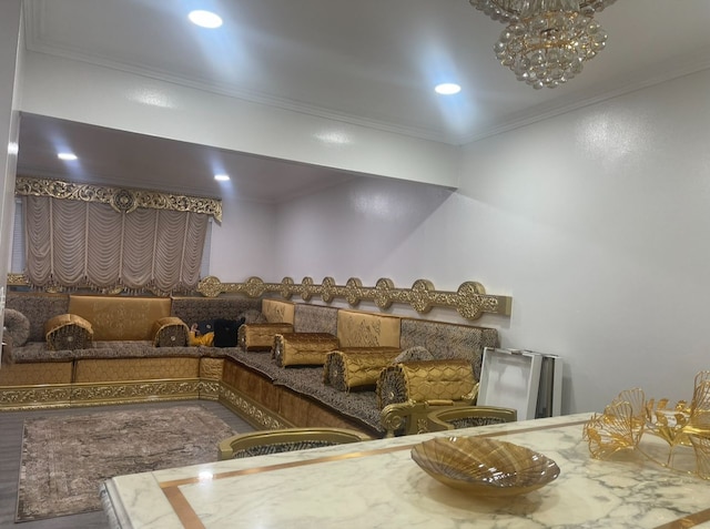 home theater room featuring an inviting chandelier and crown molding