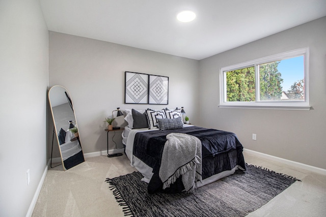 bedroom with light colored carpet