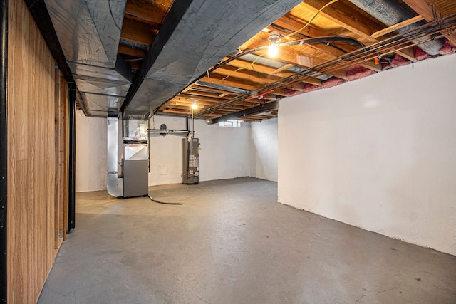 basement featuring heating unit and gas water heater