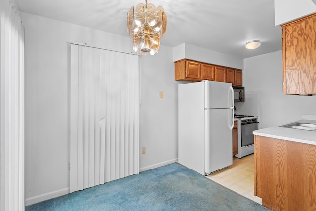 kitchen with a notable chandelier, white appliances, light colored carpet, hanging light fixtures, and sink