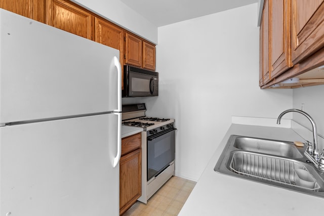 kitchen featuring sink and white appliances