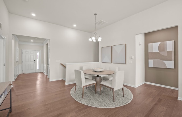 dining room with dark hardwood / wood-style flooring and a chandelier