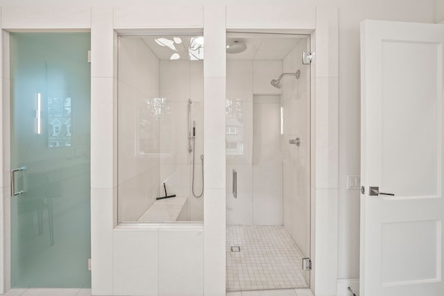 bathroom featuring tile patterned floors and a shower with door