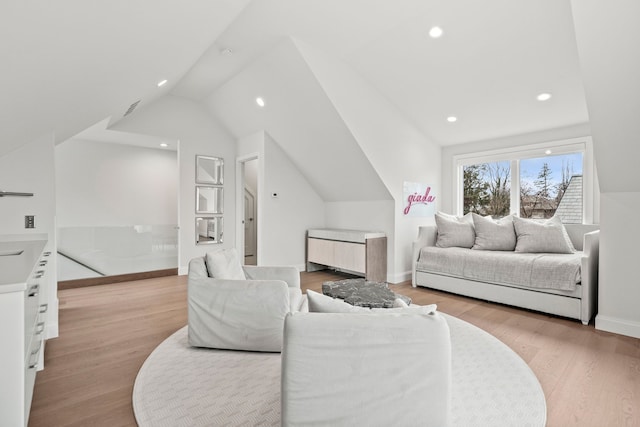 living room featuring light hardwood / wood-style floors and lofted ceiling