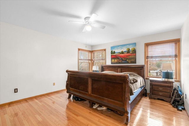 bedroom featuring multiple windows, ceiling fan, and light wood-type flooring