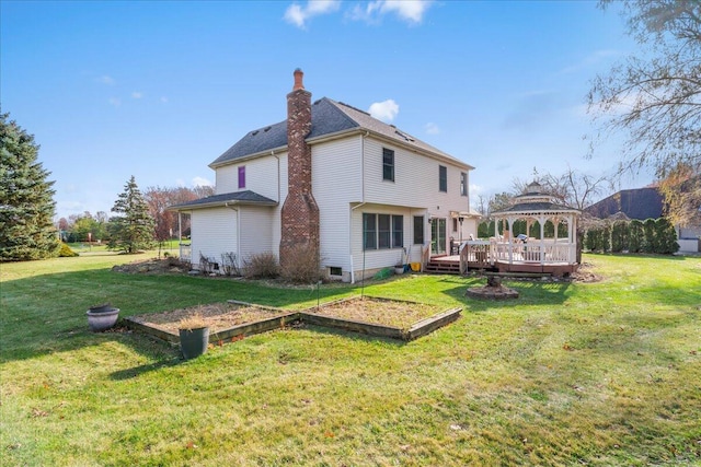 rear view of house with a lawn, a wooden deck, and a gazebo