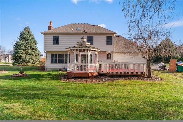 back of property with a gazebo, a yard, and a deck