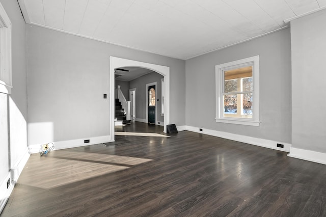 unfurnished room with dark wood-type flooring and crown molding