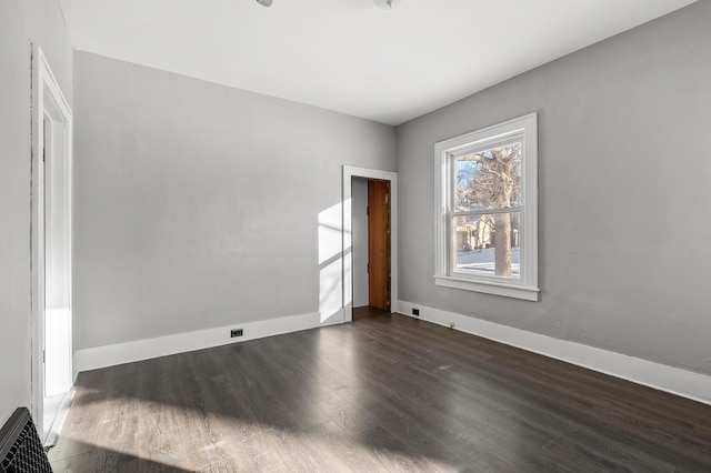 spare room with dark hardwood / wood-style floors