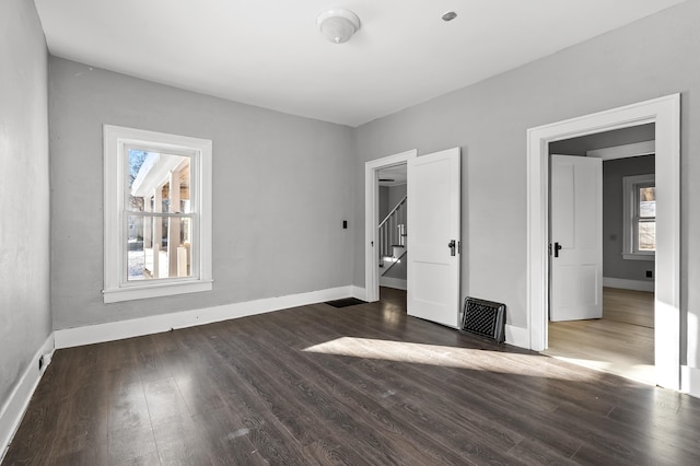 unfurnished bedroom with dark hardwood / wood-style floors