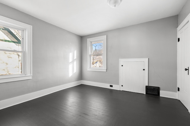 spare room featuring dark hardwood / wood-style floors