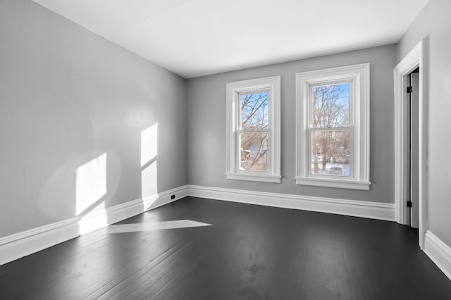 unfurnished room with dark hardwood / wood-style floors