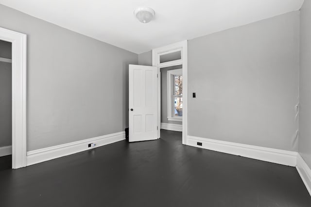 unfurnished bedroom with dark wood-type flooring