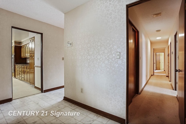 hallway featuring a textured ceiling