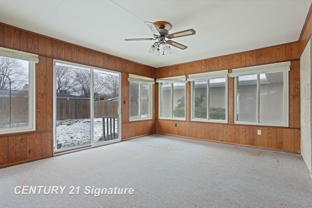 unfurnished sunroom featuring ceiling fan