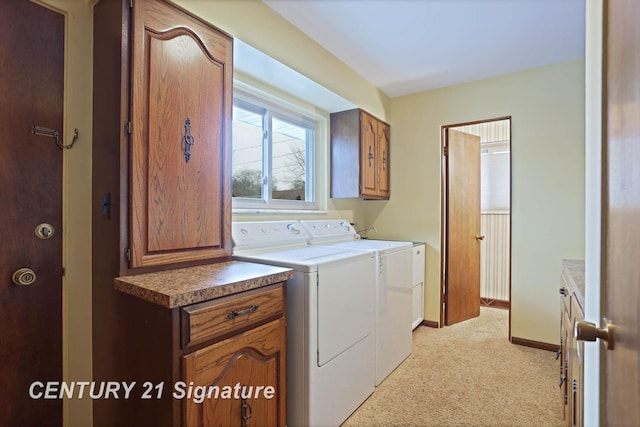 washroom with separate washer and dryer and cabinets