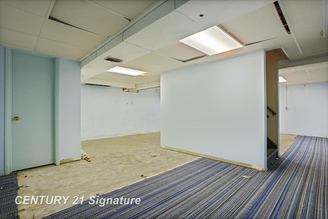 basement featuring a drop ceiling