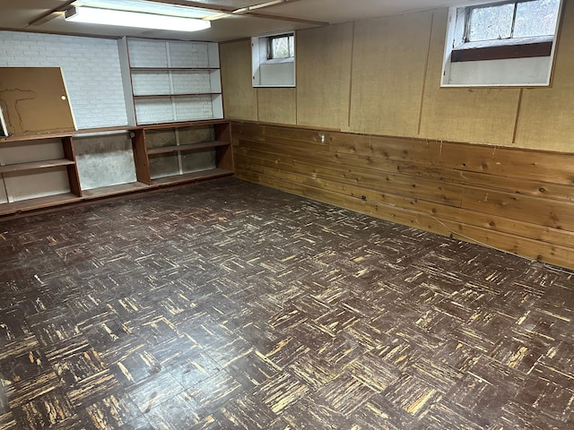 basement with wooden walls and dark floors