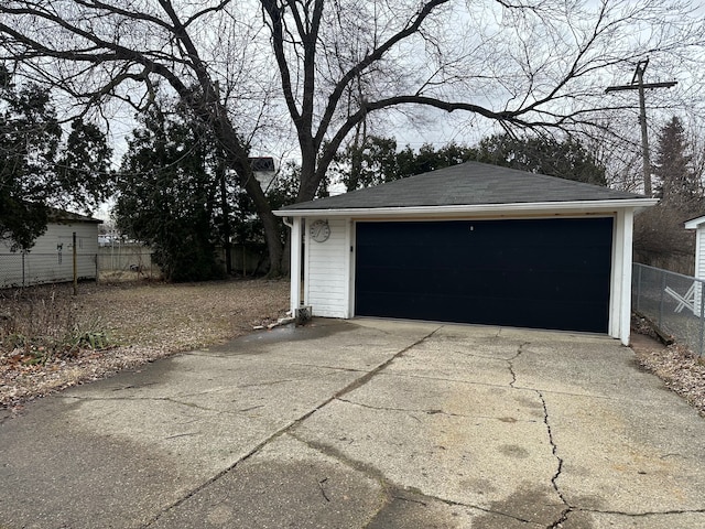 detached garage featuring fence