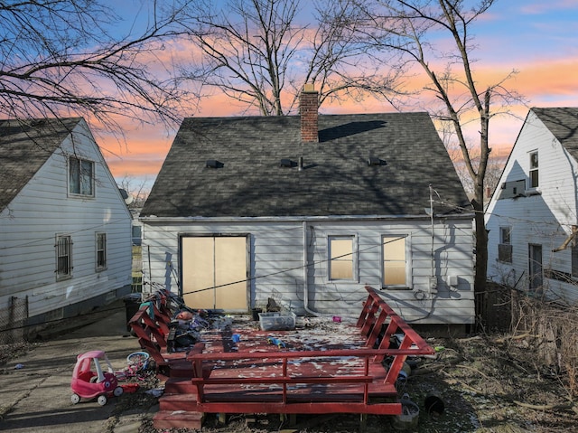 view of back house at dusk