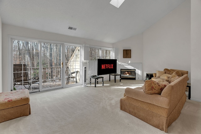 living room featuring lofted ceiling and light carpet