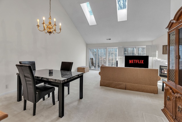 dining space featuring light carpet, high vaulted ceiling, and an inviting chandelier