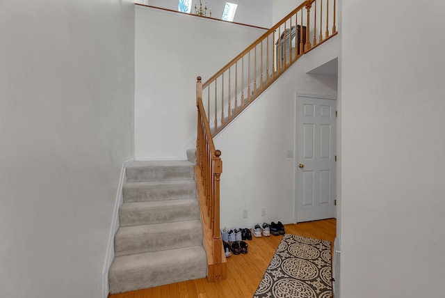 stairs featuring hardwood / wood-style flooring