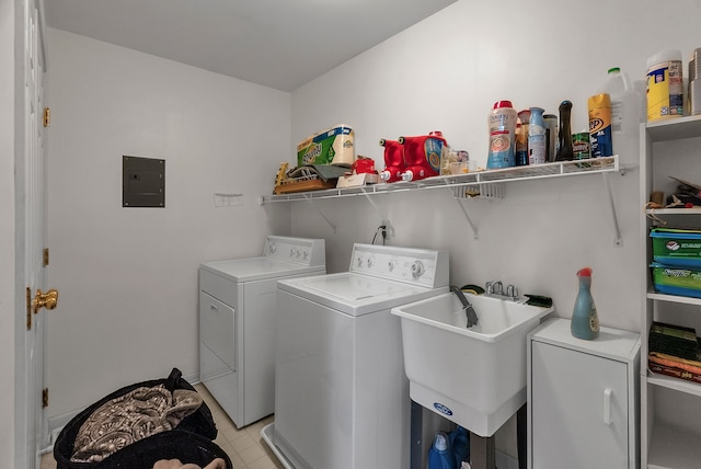 laundry room with washer and dryer, electric panel, and sink