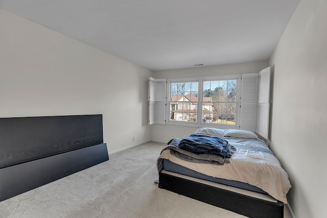 bedroom featuring light carpet