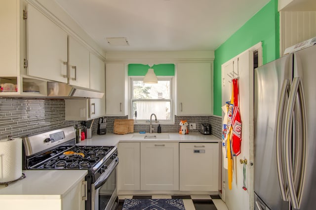 kitchen with tasteful backsplash, appliances with stainless steel finishes, sink, and white cabinets