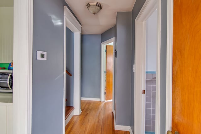 corridor with light hardwood / wood-style flooring