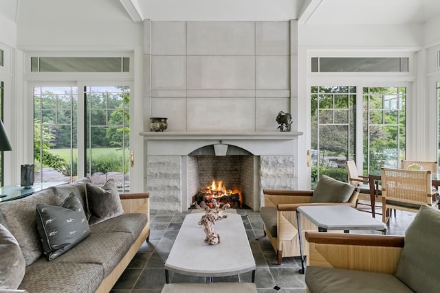 living room featuring a tiled fireplace