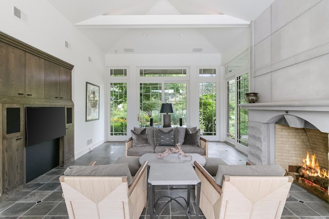 living room featuring beamed ceiling, a large fireplace, and high vaulted ceiling