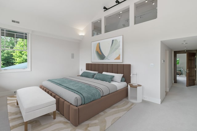 carpeted bedroom featuring a high ceiling