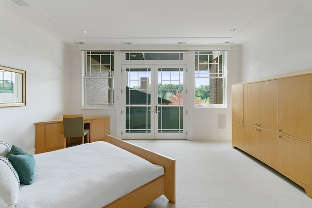 bedroom featuring access to outside, crown molding, french doors, and light colored carpet