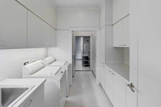 laundry room with cabinets, sink, and washing machine and clothes dryer