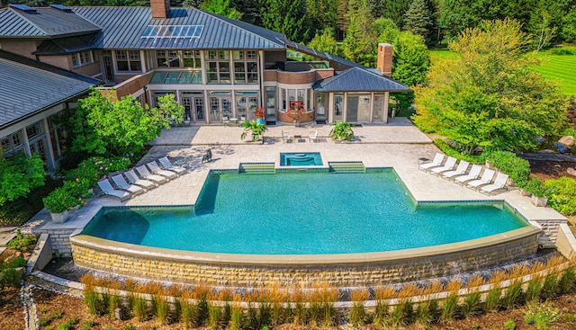 view of swimming pool with an in ground hot tub and a patio