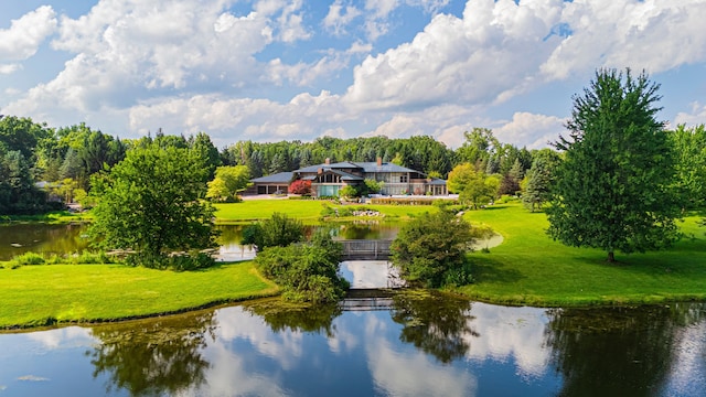 view of community featuring a yard and a water view