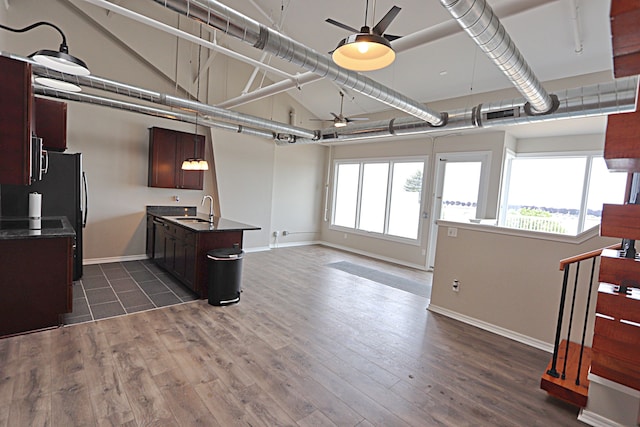 kitchen with a center island with sink, ceiling fan, dark hardwood / wood-style flooring, and sink