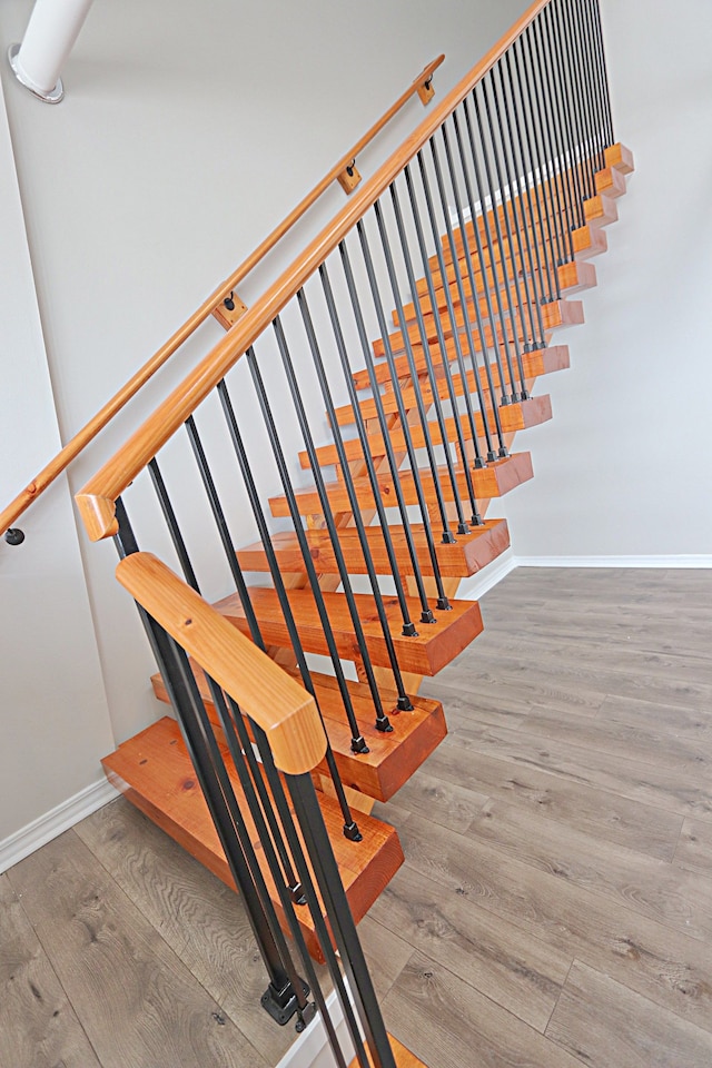 stairway featuring hardwood / wood-style flooring