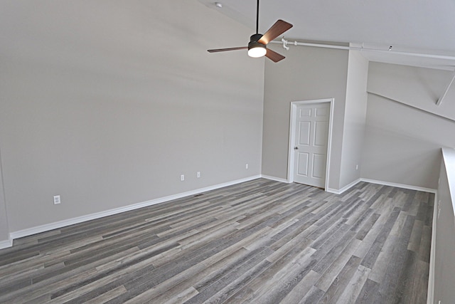 empty room with wood-type flooring, high vaulted ceiling, and ceiling fan