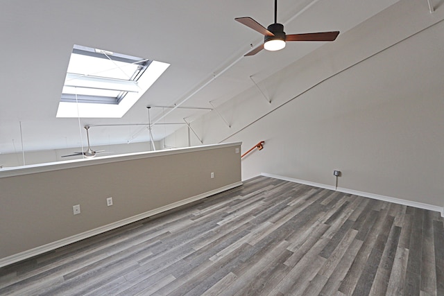 bonus room featuring ceiling fan, wood-type flooring, and lofted ceiling with skylight