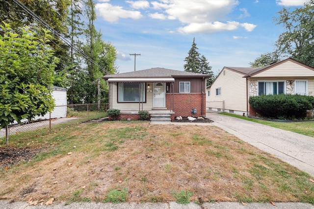 bungalow-style home with a front lawn