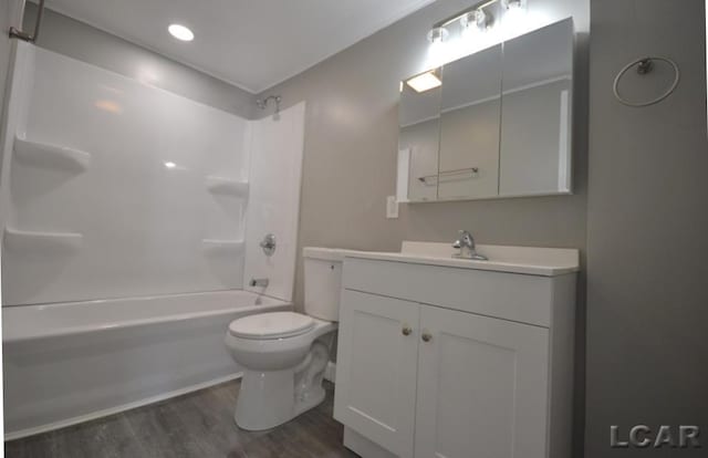 full bathroom with vanity, toilet, tub / shower combination, and hardwood / wood-style floors